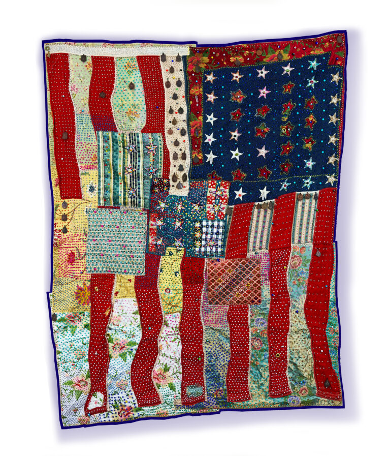 A sewn and beaded quilt depicting an abstracted American Flag.