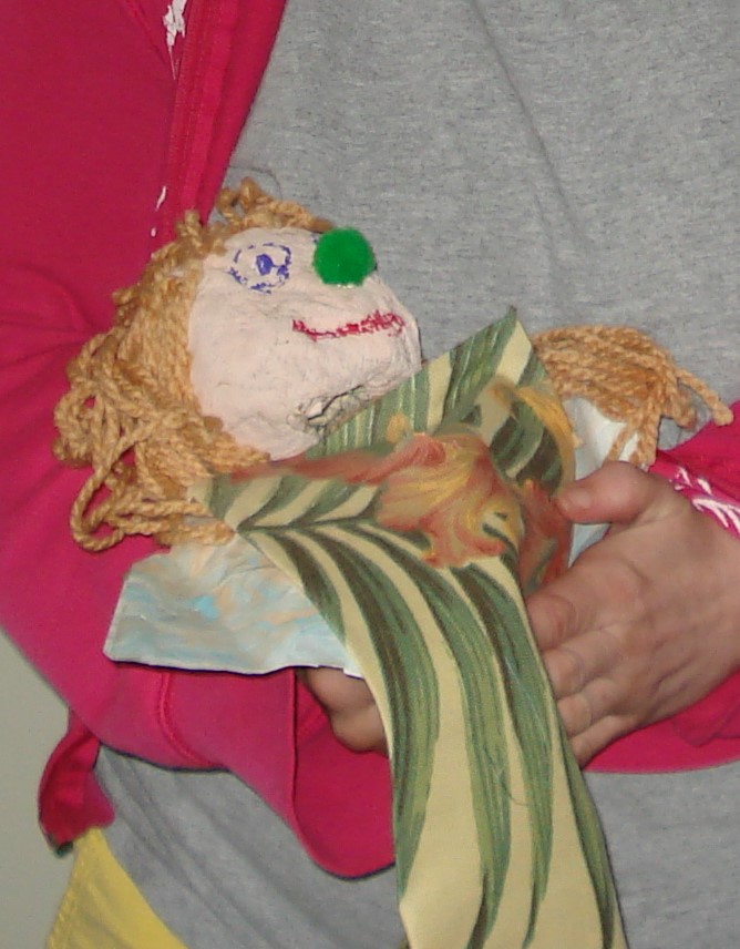 A puppet with a green a yellow body